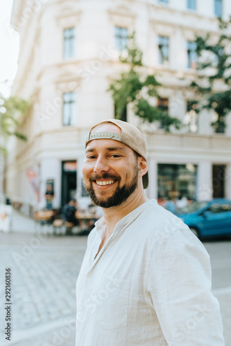 Photography Headshot of smiling bearded man wearing a baseball cap