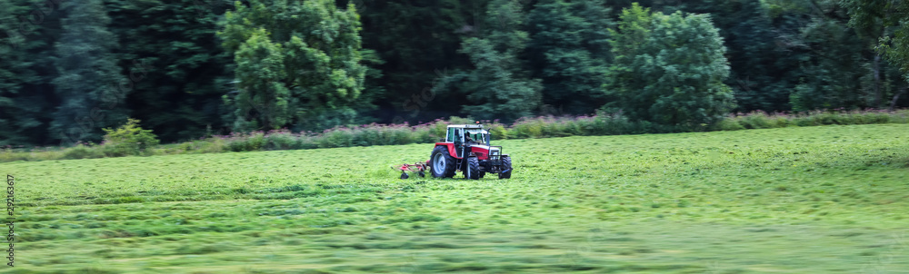 a tracor on a meadow speed blur panorama a tracor on a meadow speed blur panorama