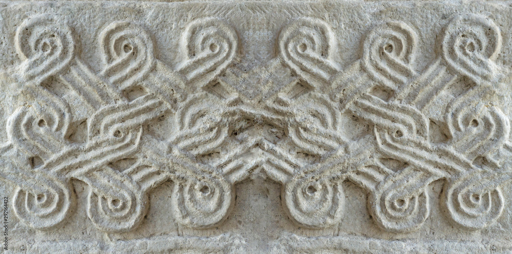 Christian pattern carved in stone on the wall of an old Christian church in Georgia