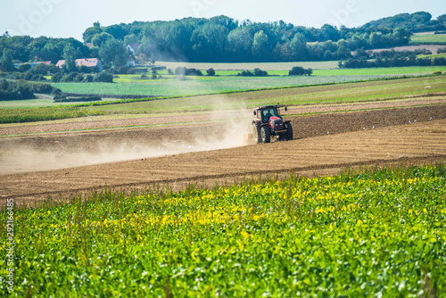 nice view of a farmer plowing his fields