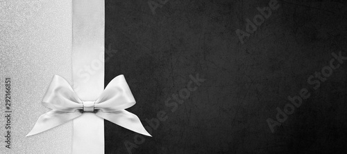 black gift card with silver ribbon bow, black friday concept