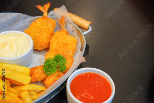 french fries and hash brown serve with chilli sauce and mayonnaise on matal dish.