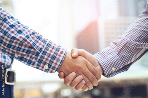 Closeup of a businessman hand shake between two colleagues OK, succeed in business Holding hands. Leave space to write a description of the message.