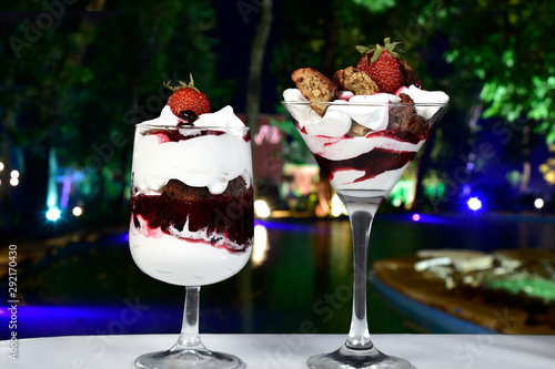 dessert in bowl with fruits on blurred background.