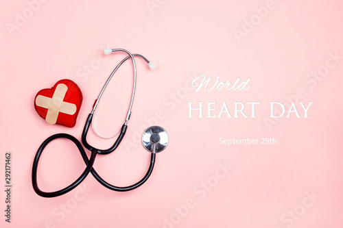 World heart day concept  with stethoscope and heart with adhesive plaster.