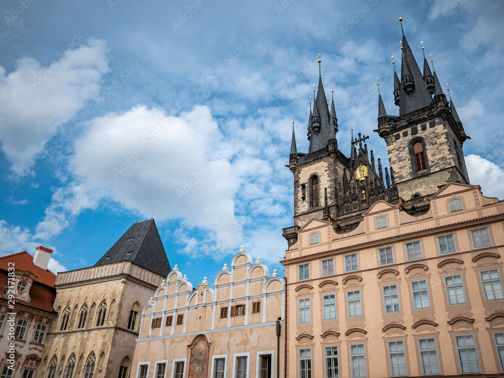 The imposing gothic spires of the Tyn Church overlooking the traditional Old Town architecture in Prague, the Czech Republic capital city.