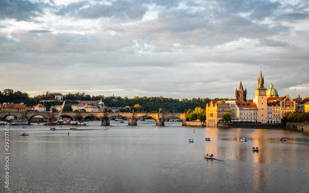 Obraz premium Prague and the Vlatava River, Czech Republic. Urban landscape of the famous landmark Charles Bridge and Old Town Bridge Tower at dusk.