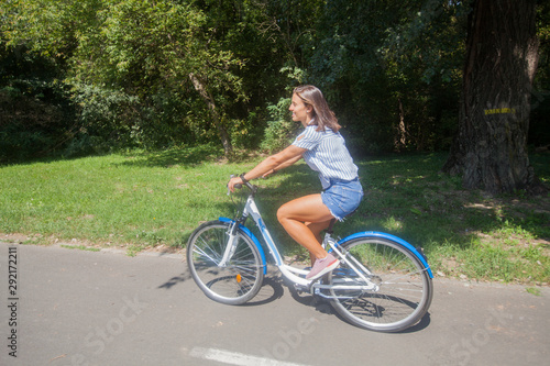  Young Woman Riding Bicycle In The Park