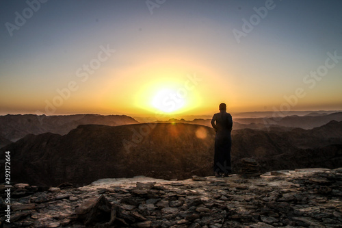 monk standing on a hill at the sunset