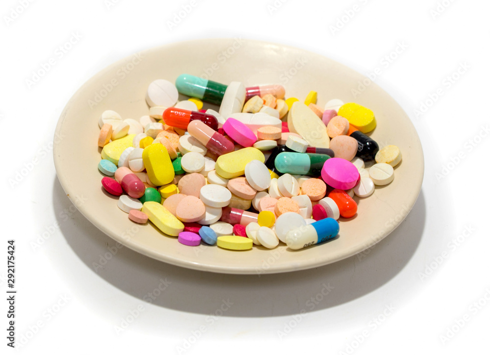 Different drug and pill on the plate isolated on white background for polypharmacy or multiple medication in elderly concept. Rational drug use concept. Copy sapce is also provided. Different drug and pill on the plate isolated on white background for polypharmacy or multiple medication in elderly concept. Rational drug use concept. Copy sapce is also provided.