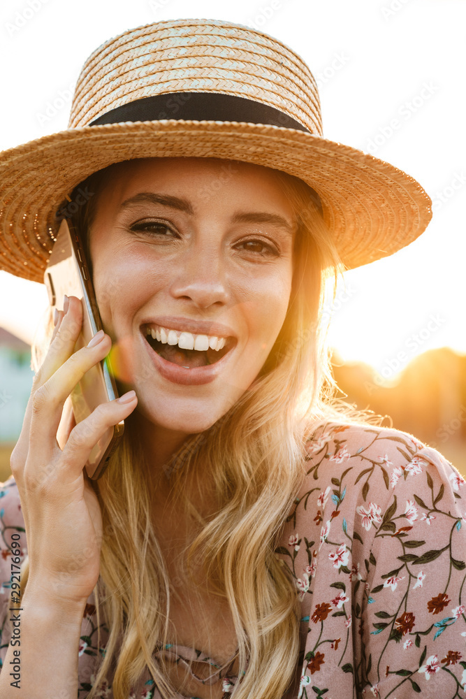 Photo of joyful caucasian woman talking on cellphone