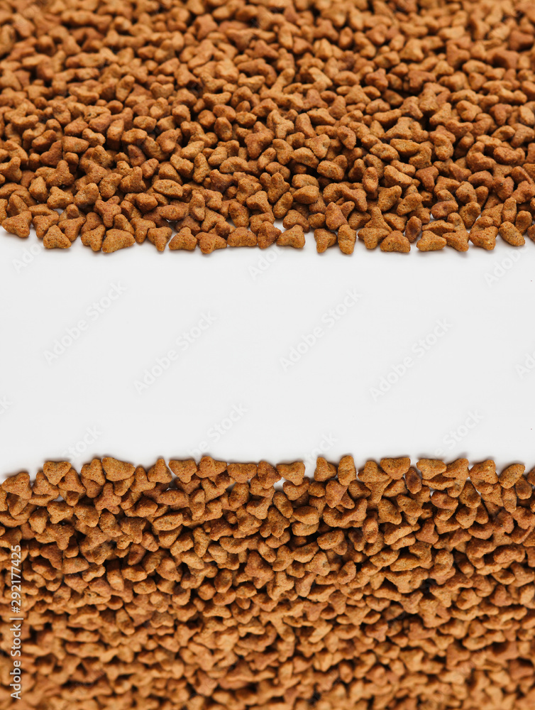 Dry pet food texture background. Medium size triangular pieces. Food pattern. Chewing treats for pets. Isolation on white. Dry pet food texture background. Medium size triangular pieces. Food pattern. Chewing treats for pets. Isolation on white.