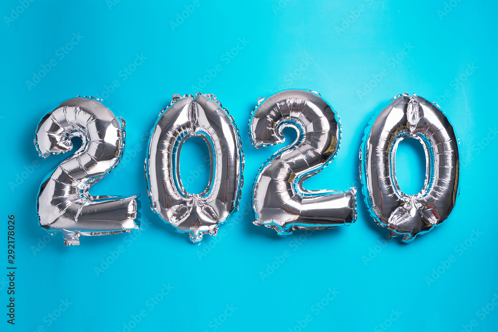 Metallic 2020 New Year balloons isolated on blue. Metallic 2020 New Year balloons isolated on blue.