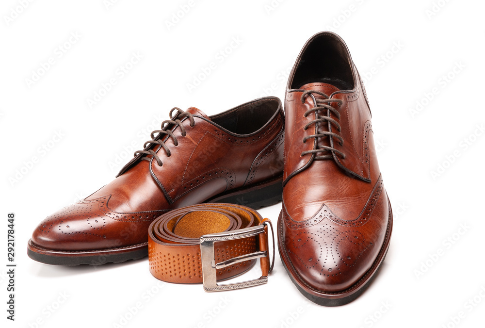Men's patent leather shoes and belt on white