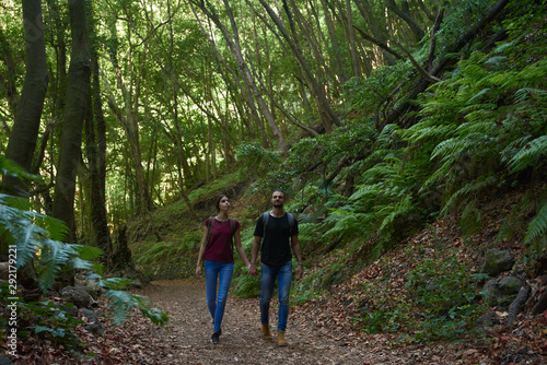 Couple talking a romantic walk in the woods