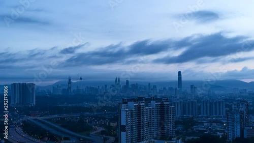 beautiful blue hour scene time lapse motion, moving clouds over Kuala Lumpur city, aerial view. Blue sky.