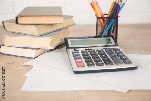 book with calculator and pencils