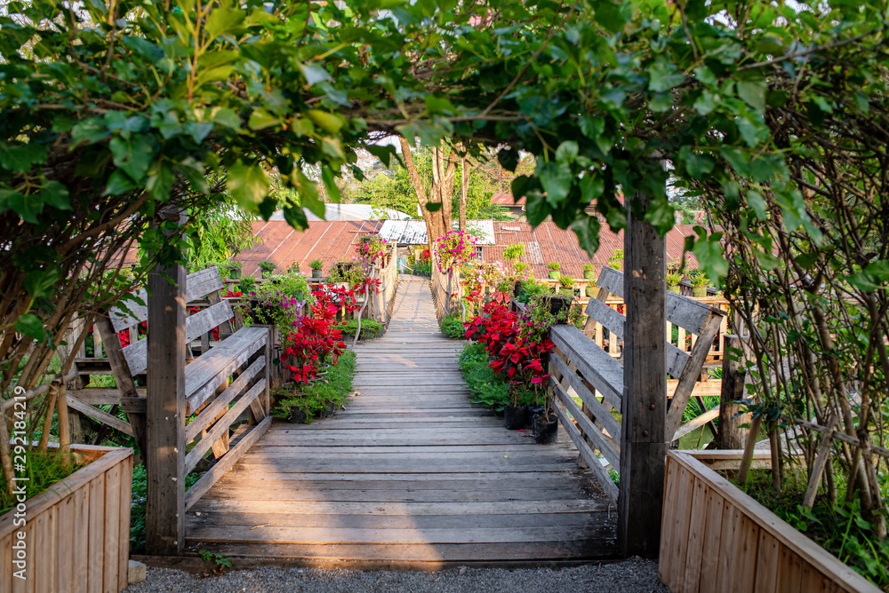Wooden bridge with flowers on both sides Wooden bridge with flowers on both sides