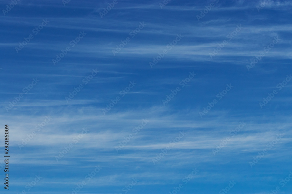 Contrast photo of white clouds on a bright blue background high in the sky