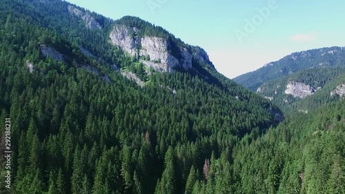 Ascending aerial shot, showing the mountains in the Lower Tatras region with lots of trees. photo