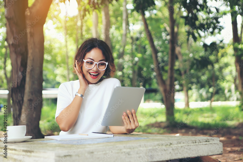 Fototapeta premium A happy businesswoman because she saw the profits shown in her tablet.