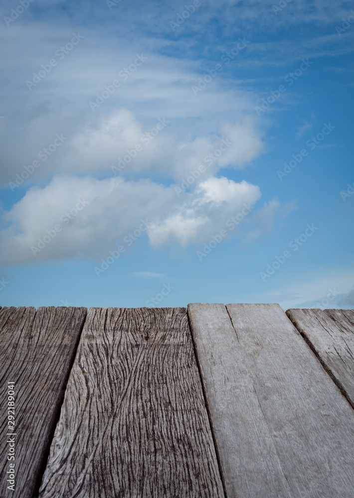 Empty old wood floor with blue sky background. Empty old wood floor with blue sky background.