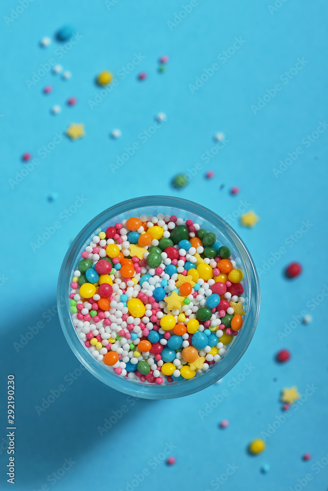 Colorful small candy on blue background