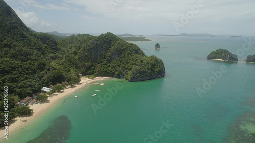 Aerial view islands with sand beach and turquoise water in blue lagoon among coral reefs, Caramoan Islands, Philippines. Landscape with sea, tropical beach. © Alex Traveler