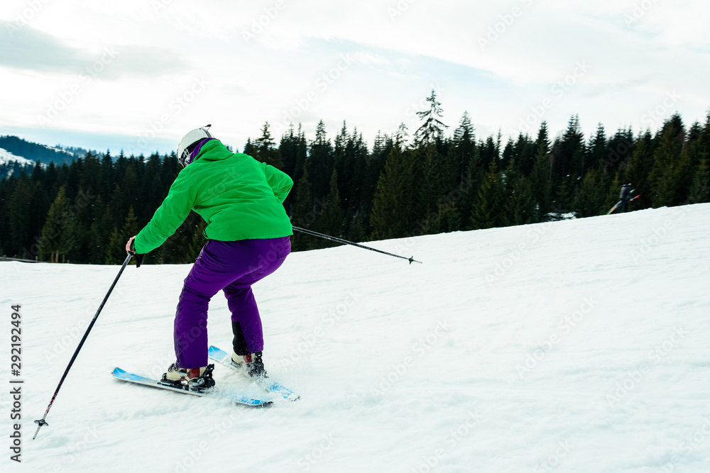 A young man is skiing in the Carpathians on the slopes.