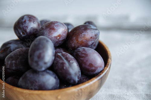 plums in wood plate