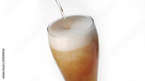 Beer poured in glass on black background