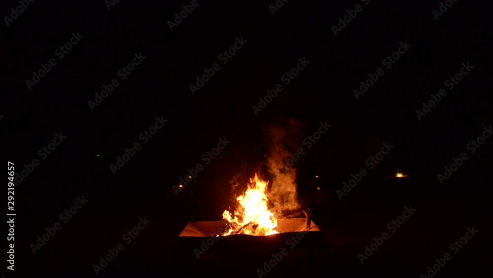 A campfire burning in the Sahara desert in the night in Erg Chegaga luxury desert camp in Morocco. A campfire burning in the Sahara desert in the night in Erg Chegaga luxury desert camp in Morocco.