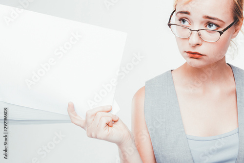 Female leadership. Failed deadlines. Dissatisfied demanding business woman with blank papers. photo