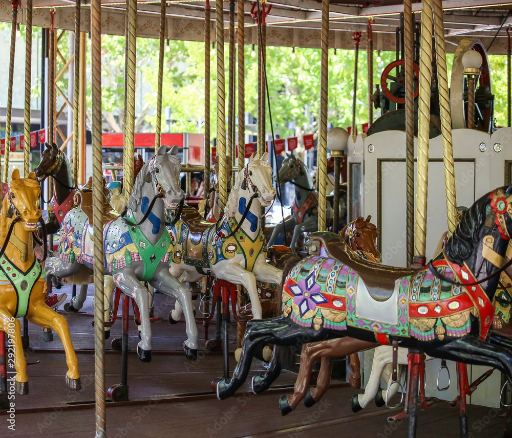 Merry-go-round with horses. Carousel with horses. Amusement Park in the city