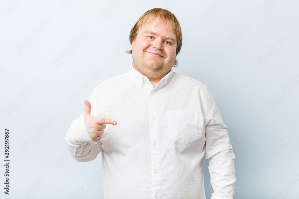 Young authentic redhead fat man person pointing by hand to a shirt copy space, proud and confident Young authentic redhead fat man person pointing by hand to a shirt copy space, proud and confident