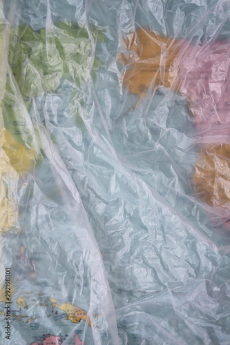 Clear plastic bag texture background. Earth map. Waste recycling concept. Crumpled polyethylene and cellophane.