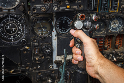 Pilot's hand on the military aircraft control knob. In the cockpit of an old, Soviet military jet. Close-up. Text translation from Russian 