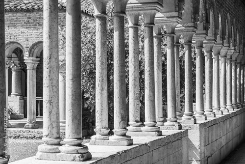 Colonnade of medieval italian building - black and white photo