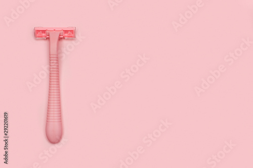 Pink woman shaver isolated on pink paper background. Copy space, place for text. Flat lay. Shaving concept.