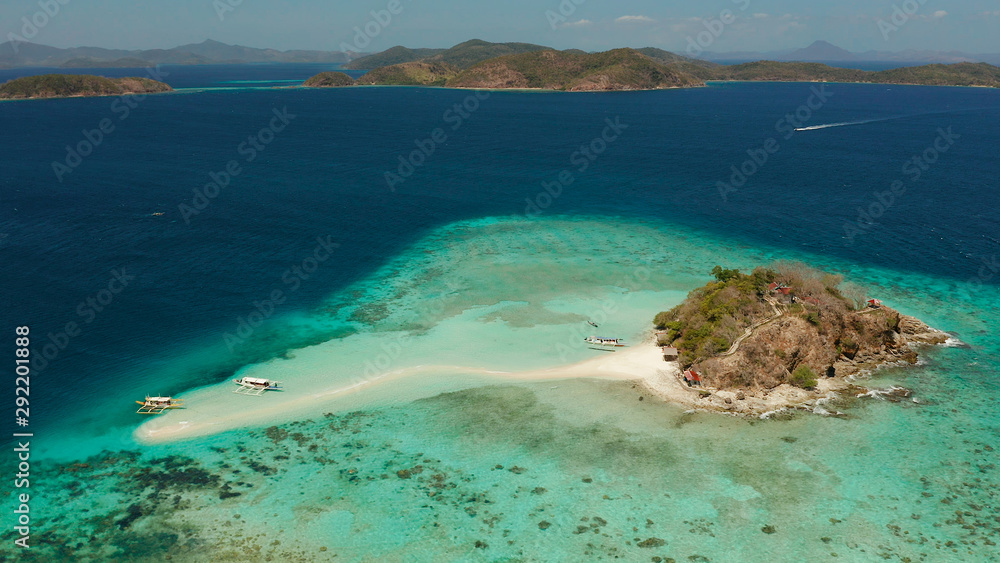 Tropical island and sand beach, turquoise water and coral reef, aerial view. Philippines, Palawan. tourist boats on coast tropical island.