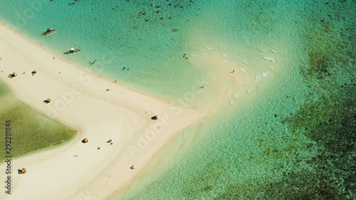 Tropical white island and sandy beach with tourists surrounded by coral reef and blue sea, aerial view. Sandbar Atoll. Island with sand bar and coral reef. Summer and travel vacation concept, Camiguin © Alex Traveler