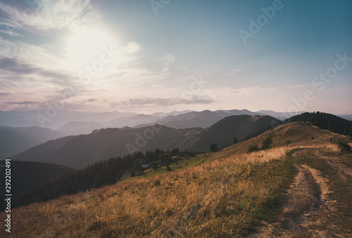 Carpathian mountains summer sunset with road on foreground