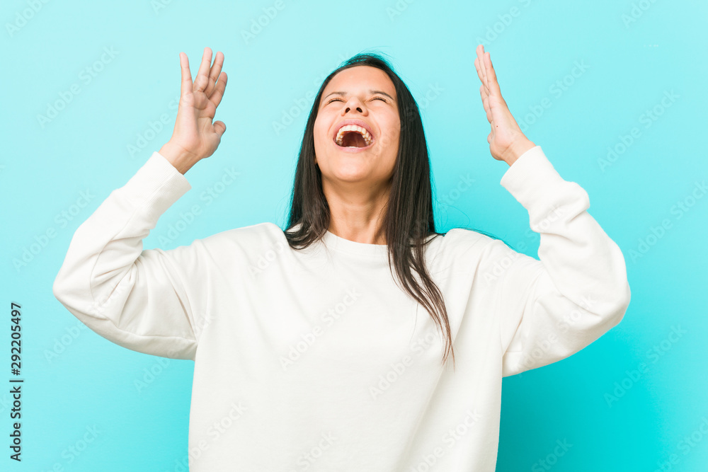 Young pretty hispanic woman screaming to the sky, looking up, frustrated. Young pretty hispanic woman screaming to the sky, looking up, frustrated.