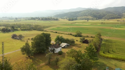 High aerial orbit to left in sun around the Pearl S. Buck birthplace museum in Hillsboro, West Virginia. photo