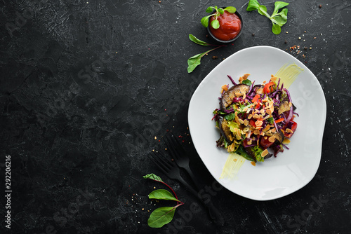 Eggplant salad and fresh vegetables with nuts. Top view. Free space for your text.