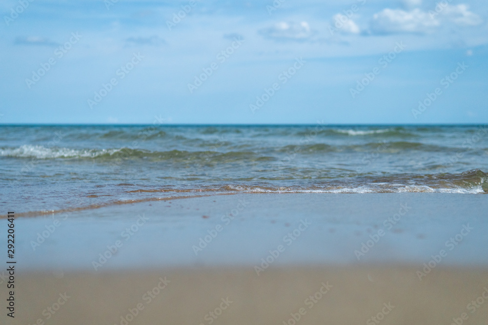 Beautiful waves rolling up on a sandy beach. Summertime in Österlen, Sweden. Beautiful waves rolling up on a sandy beach. Summertime in Österlen, Sweden.
