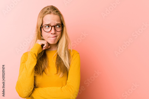 Adorable teenager woman confused, feels doubtful and unsure.