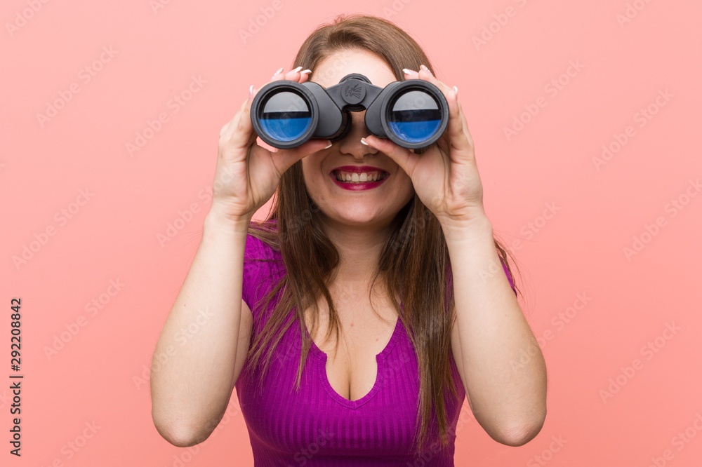 Young caucasian woman looking through binoculars Young caucasian woman looking through binoculars