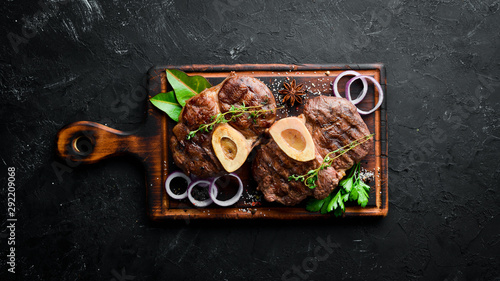 Osso buco cooked Veal shank on a black background. Top view. Free space for your text. photo