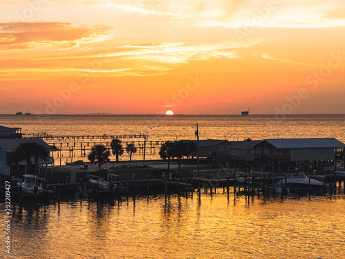 A golden hour sunset over a marina and bay.